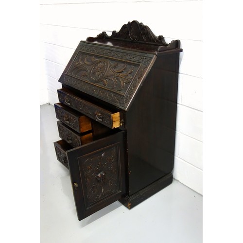 229 - Victorian carved oak bureau with a fall front and 4 drawers and a panelled door below, 125 x 91 x 50... 