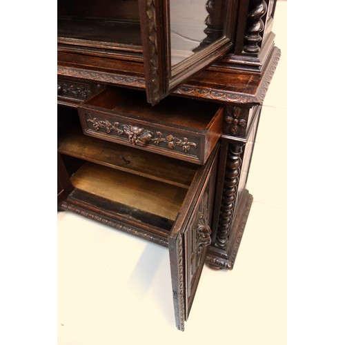 230 - 19th Century Flemish carved oak cabinet with 2 arch glazed panelled doors above, 2 drawers and 2 pan... 