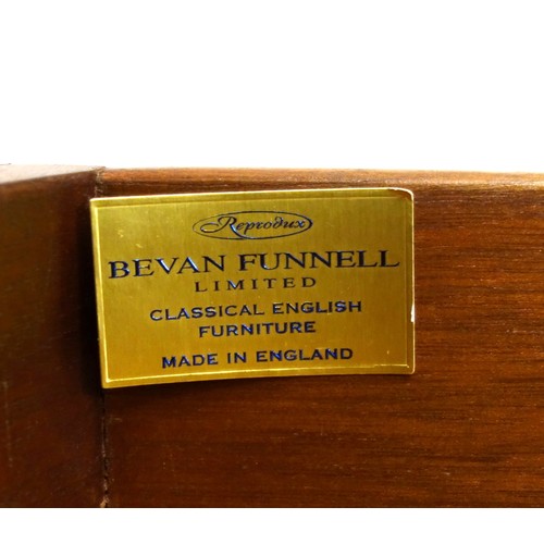 231 - Bevan Funnell Reprodux mahogany serpentine pedestal desk with an inset gilt tooled brown leather top... 