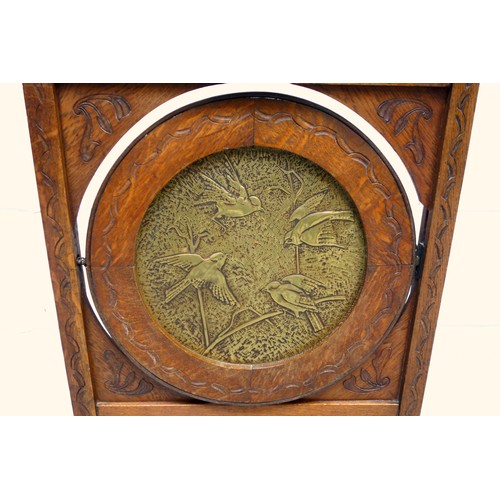 246 - Unusual Aesthetic Movement oak metamorphic firescreen with central brass panel decorated in relief w... 