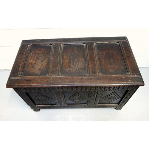 250 - 17th Century carved oak chest with a triple diamond panelled front and a hinged triple panelled top,... 