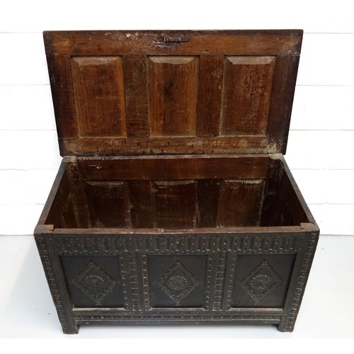 250 - 17th Century carved oak chest with a triple diamond panelled front and a hinged triple panelled top,... 