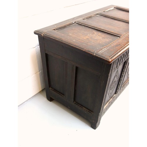 250 - 17th Century carved oak chest with a triple diamond panelled front and a hinged triple panelled top,... 