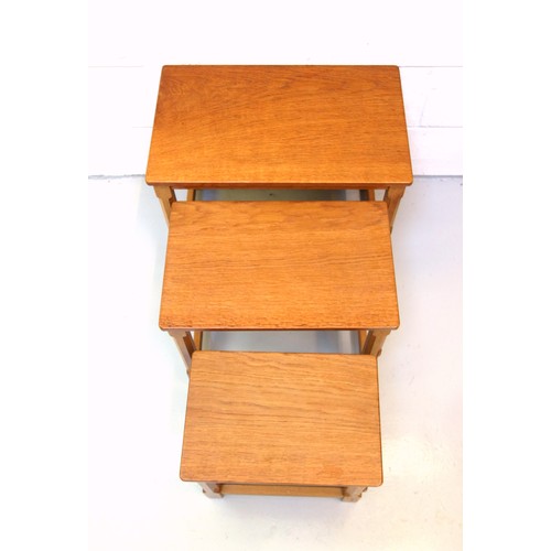 254 - Mouseman, (Robert Thompson), oak nest of three graduating rectangular tables, each with an adzed top... 