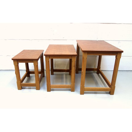 254 - Mouseman, (Robert Thompson), oak nest of three graduating rectangular tables, each with an adzed top... 