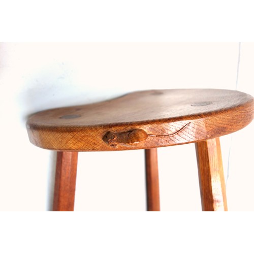 257 - Mouseman, (Robert Thompson), oak kidney shaped stool with 3 tapering octagonal legs, (one leg broken... 