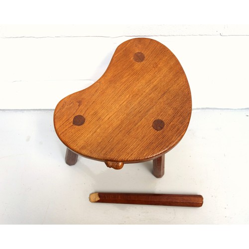 257 - Mouseman, (Robert Thompson), oak kidney shaped stool with 3 tapering octagonal legs, (one leg broken... 