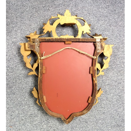 266 - Wall Mirror with a shield shaped plate in a gilt floral and scroll decorated frame 83 x 69cm overall