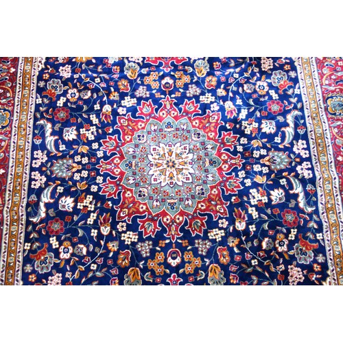 272 - Persian Tabriz carpet, the indigo field with a central medallion and all-over stylised floral decora... 