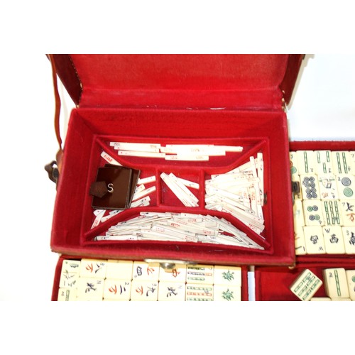 341 - Chinese Mahjong set with bone and bamboo tiles and counters, in a felt lined leather case, W.24.5cm