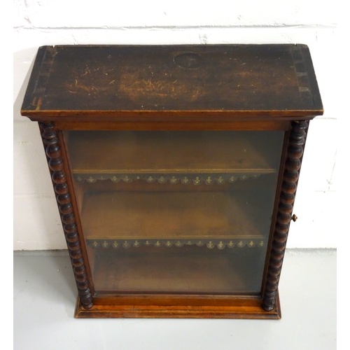 224 - Edwardian mahogany cabinet with a glazed panelled door flanked by bobbin turned pilasters, on a plin... 