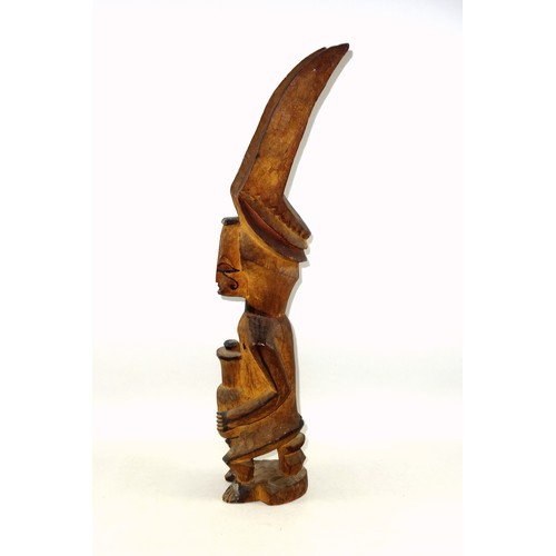 292 - 19th Century Nigerian Igbo Ikenga spiritual shrine figure, depicted seated holding a bottle with a p... 