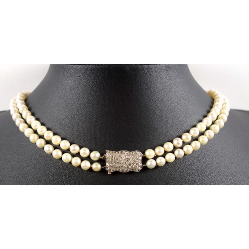 176 - Art Deco, two strand pearl necklace with 18ct white gold clasp, profusely set with diamonds in a 'su... 