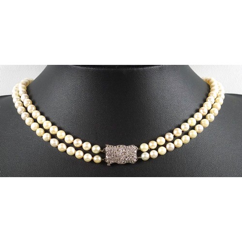 176 - Art Deco, two strand pearl necklace with 18ct white gold clasp, profusely set with diamonds in a 'su... 