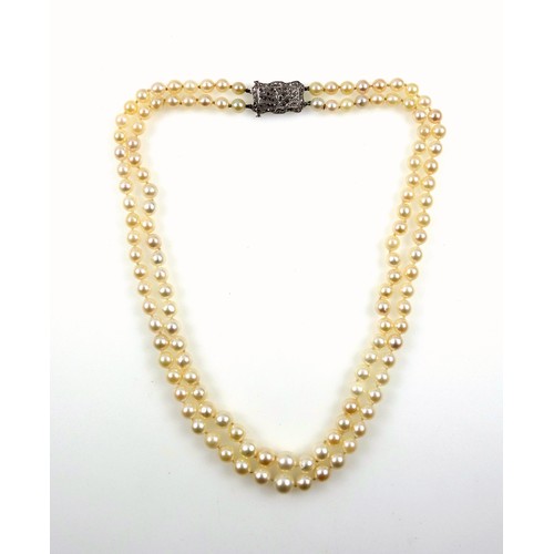 176 - Art Deco, two strand pearl necklace with 18ct white gold clasp, profusely set with diamonds in a 'su... 