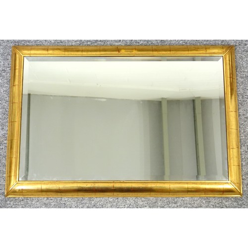 263 - Belgian wall mirror with a bevelled rectangular plate within a mirror slip border, in a gilt decorat... 