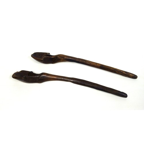 110 - Two similar large African hardwood tribal spoons, 52cm and 52.8cm respectively (2)