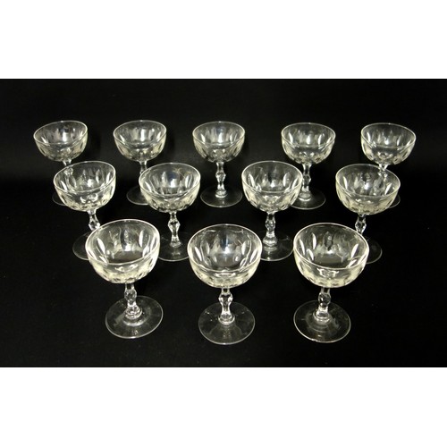 71 - Set of 12 Edwardian cut glass champagne coupes, each with pointed elliptical decoration to the bowl ... 