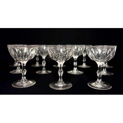 71 - Set of 12 Edwardian cut glass champagne coupes, each with pointed elliptical decoration to the bowl ... 