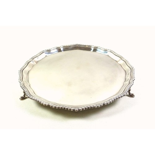 125 - Late Victorian silver salver with a scalloped and gadrooned rim on 3 hoof feet, by Carrington & Co.,... 