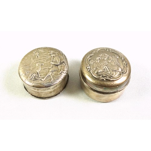 132 - Edwardian silver circular pill box, the cover embossed with a mother and child, with a gilt interior... 