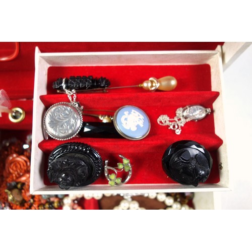 152 - Costume Jewellery - A musical jewellery box containing four jet brooches, lucky silver enamelled clo... 