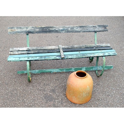 406 - Wrought iron garden bench with weathered painted teak slats, on scroll legs, W.173cm, and a terracot... 