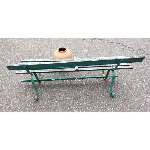 406 - Wrought iron garden bench with weathered painted teak slats, on scroll legs, W.173cm, and a terracot... 