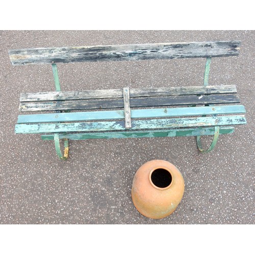 406 - Wrought iron garden bench with weathered painted teak slats, on scroll legs, W.173cm, and a terracot... 