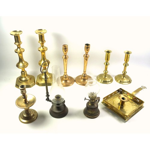 528 - Pair of George II brass candlesticks, each with a tall capital on a knopped baluster column and 