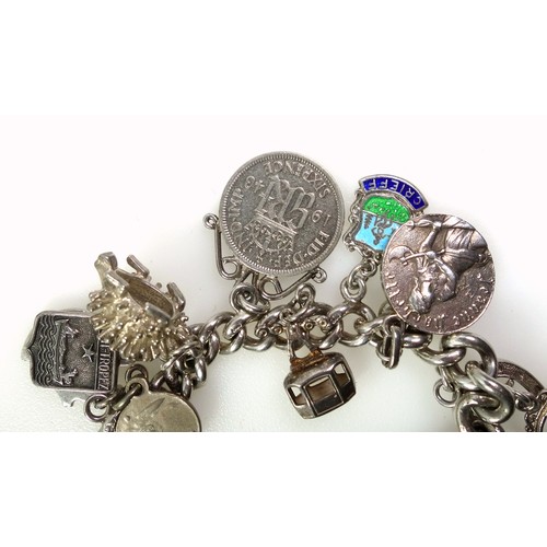 161 - Silver bracelet with a George IV shilling, 1826, George VI 6d, 1943, and 17 charms; Greek key style ... 