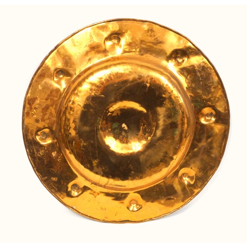 402 - Liberty style copper charger with a raised centre and a broad rim with 8 roundels in relief, Dia.45.... 