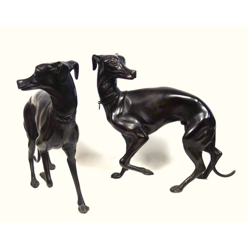 415 - A pair of bronzed sculptures of whippets, 20th century, unsigned, after P J Mene with head turned an... 