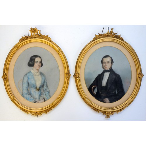 193 - 19th century pastel portraits of a female in blue dress and a male in black with bow tie, each set w... 