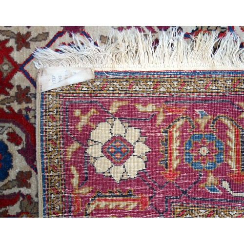 238 - South Caucasian Karabagh rug, the camel-coloured field with all-over herati pattern, within a madder... 