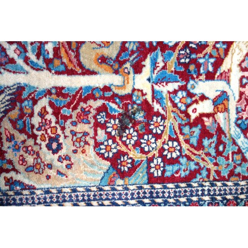 239 - Kashmiri rug, the madder field with all-over 