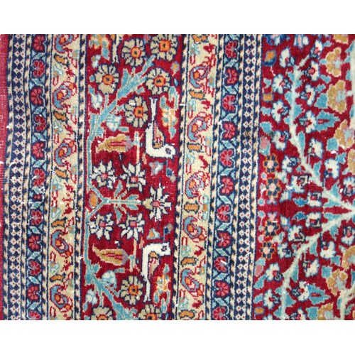 239 - Kashmiri rug, the madder field with all-over 