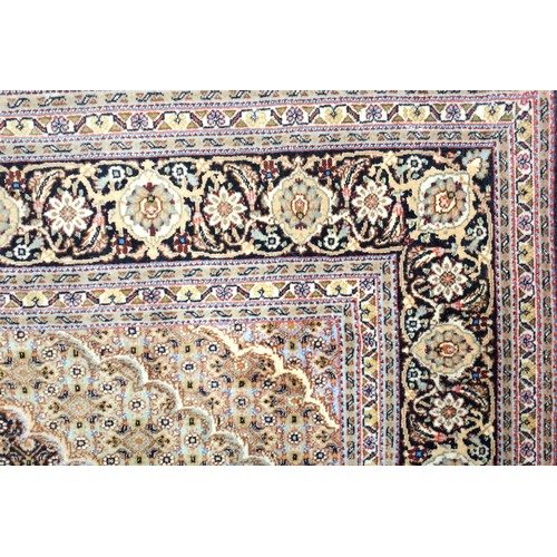 247 - Persian Tabriz rug, the noire field with a taupe lozenge medallion with pendants, spandrels, and all... 