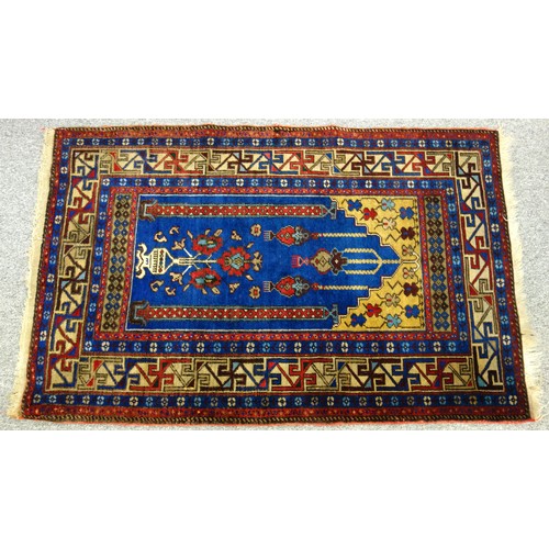 250 - Turkish Yahyali prayer rug, the indigo field with a floral vase beneath 3 lanterns flanked by 2 colu... 