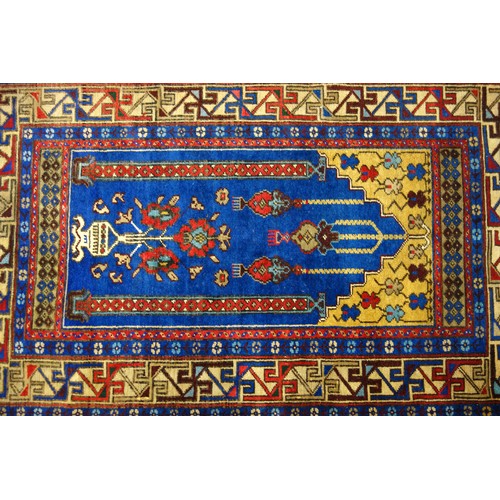 250 - Turkish Yahyali prayer rug, the indigo field with a floral vase beneath 3 lanterns flanked by 2 colu... 