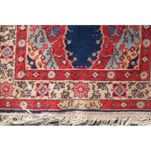 255 - Persian rug, the madder field with all-over geometric pattern, within a floral border and rosette gu... 