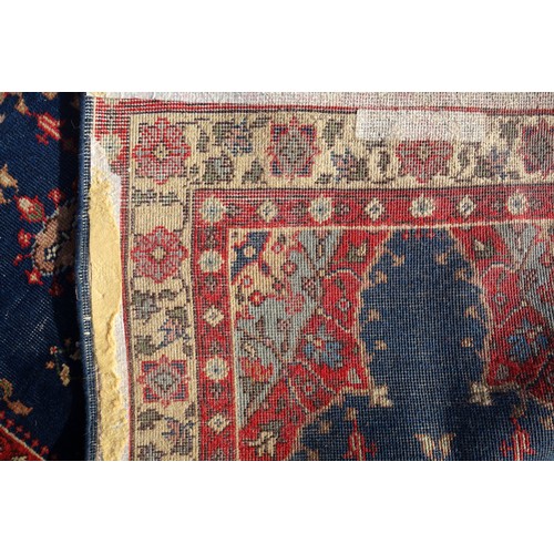 255 - Persian rug, the madder field with all-over geometric pattern, within a floral border and rosette gu... 