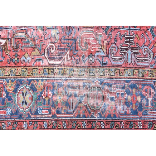 262 - Early 20th Century Persian Heriz carpet, the coral field with all-over scroll decoration, within an ... 