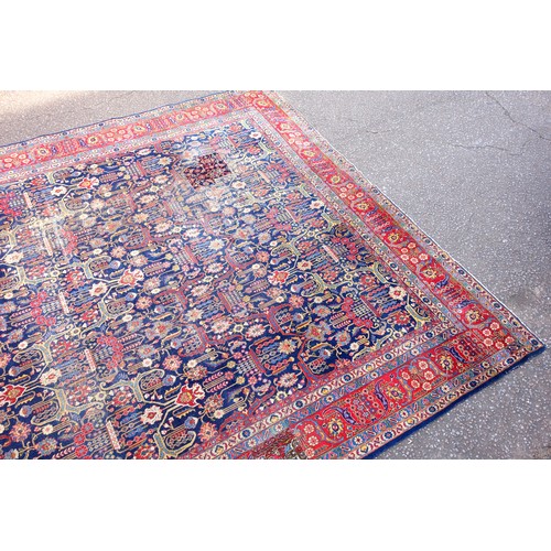 267 - Large Early 20th Century Persian Tabriz carpet, the indigo field with all-over palmette, rosette, an... 