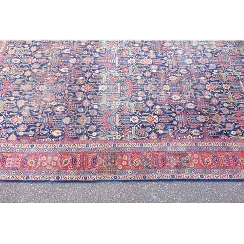 267 - Large Early 20th Century Persian Tabriz carpet, the indigo field with all-over palmette, rosette, an... 