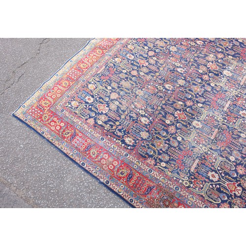 267 - Large Early 20th Century Persian Tabriz carpet, the indigo field with all-over palmette, rosette, an... 