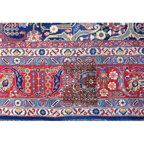 267 - Large Early 20th Century Persian Tabriz carpet, the indigo field with all-over palmette, rosette, an... 