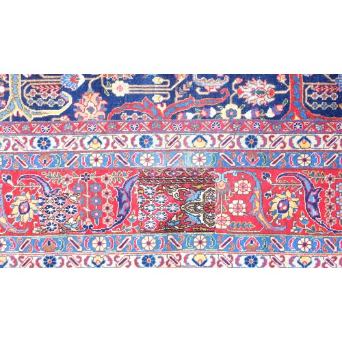 267 - Large Early 20th Century Persian Tabriz carpet, the indigo field with all-over palmette, rosette, an... 