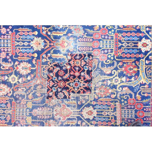 267 - Large Early 20th Century Persian Tabriz carpet, the indigo field with all-over palmette, rosette, an... 