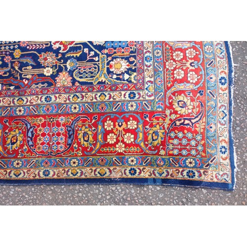 267 - Large Early 20th Century Persian Tabriz carpet, the indigo field with all-over palmette, rosette, an... 